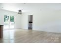 Spacious living room with new flooring, large windows, sliding glass door, and modern lighting at 1537 Spangler Dr, Shelby, NC 28150