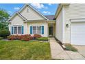 Inviting two-story home with blue shutters, lush landscaping, and a walkway to the front door at 170 Heywatchis Dr, Mooresville, NC 28115