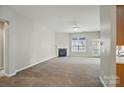 Spacious living room featuring a fireplace, ceiling fan and carpet at 170 Heywatchis Dr, Mooresville, NC 28115