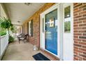 Inviting front porch with a blue door, classic brickwork and comfortable seating, creating a cozy entrance at 1753 Elmwood Dr, Rock Hill, SC 29730