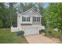 Charming two-story home with a white garage door, black shutters, and a well-manicured lawn at 1835 Allegheny Dr, Gastonia, NC 28054