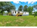 Spacious, green backyard with a wooden deck, perfect for outdoor entertaining at 2002 Kingston Rd, Kingstown, NC 28150