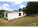 A well-kept one-story home with white siding, red shutters, and a lush, green yard at 2002 Kingston Rd, Kingstown, NC 28150