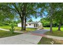 A quaint home framed by lush trees, complemented by a sidewalk and accessibility ramp at 2002 Kingston Rd, Kingstown, NC 28150