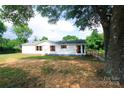 Inviting single-story home with white siding, red shutters, and a serene, tree-lined yard at 2002 Kingston Rd, Kingstown, NC 28150