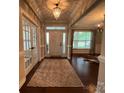 Elegant foyer featuring hardwood floors, a chandelier, and glass-paneled doors, creating a welcoming entrance at 2007 Bishops Ct, Cornelius, NC 28031