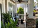 Cozy front porch with rocking chairs, sheer curtains, and stylish decor, perfect for relaxing outdoors at 2007 Bishops Ct, Cornelius, NC 28031