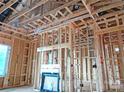 Interior framing of a new home construction with a fireplace and window at 2085 Bonds Ln # 26, Fort Mill, SC 29715