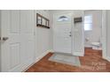 Bright foyer with hardwood floors, a mirror, and a view of the downstairs half bathroom at 244 River Clay Rd, Fort Mill, SC 29708