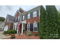 Charming brick home with black shutters, an American flag, and well-maintained landscaping in the front yard at 2763 Rivendale Ct, Indian Land, SC 29707