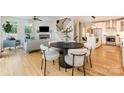 Open-concept living space with dining area, stairs to upper floor, and views to the living room and kitchen at 2845 Lakefront Dr, Belmont, NC 28012
