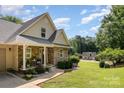 Charming stone and siding home with well-manicured front yard and covered porch offers inviting curb appeal at 2845 Lakefront Dr, Belmont, NC 28012