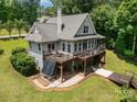 Stunning aerial view of home with expansive deck, garden, and walk-out basement to a well-manicured lawn at 2845 Lakefront Dr, Belmont, NC 28012