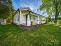 Charming home exterior with well-maintained lawn, showcasing curb appeal and landscaping at 300 W 12Th St, Salisbury, NC 28144