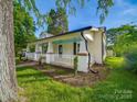 Side view of charming home with a well-manicured lawn and inviting front porch at 300 W 12Th St, Salisbury, NC 28144