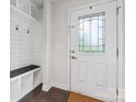 Bright entryway with tiled floor, coat rack with bench, and glass front door at 3003 Salix Bend Dr, Charlotte, NC 28205