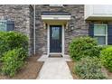 Charming front entrance featuring stone facade, covered porch, and lush landscaping at 3003 Salix Bend Dr, Charlotte, NC 28205