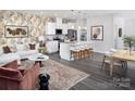 Open-concept living space featuring a modern kitchen, living room with patterned rug, and dining area at 3010 Big Bend Dr, Kannapolis, NC 28025