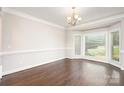Bright dining room with large bay windows, hardwood floors and elegant chandelier at 5183 Mill Race Ln, Lancaster, SC 29720