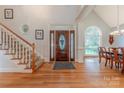 Bright foyer with hardwood floors, staircase, and decorative front door creates a welcoming entry at 6024 Highview Rd, Weddington, NC 28104