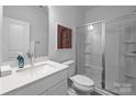 Modern bathroom features a glass-enclosed shower, white vanity with quartz countertop, and contemporary fixtures at 7122 Westrow Ave # 39, Charlotte, NC 27278