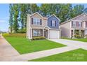 Charming two-story home featuring a manicured lawn and a welcoming two-car garage at 7205 Finnigan Rd, Charlotte, NC 28215