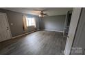 Well-lit living room boasts modern floors and a window at 824 S Laurel St, Lincolnton, NC 28092
