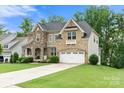 A well-manicured lawn enhances this home with stone and brick accents and an attached garage at 862 Kathy Dianne Dr, Fort Mill, SC 29707