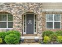Arched stone doorway and dark door featuring a decorative wreath at 862 Kathy Dianne Dr, Fort Mill, SC 29707
