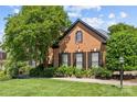 Well-manicured lawn and landscape in front of a two-story brick home at 9625 Donna Ve Ln, Charlotte, NC 28277