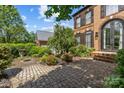 Brick two-story home with a stone walkway and manicured landscaping at 9625 Donna Ve Ln, Charlotte, NC 28277