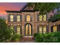 Elegant brick home featuring black trim, a double door entry, manicured shrubs, and a brick walkway at 9625 Donna Ve Ln, Charlotte, NC 28277