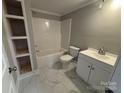 Well-lit bathroom featuring marble floors, built-in shelving, and a modern vanity with a sink at 103 Meadow Ne Ave # 6, Concord, NC 28025