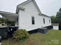 Exterior view of home with green lawn, AC Unit, and minimal landscaping at 103 Meadow Ne Ave # 6, Concord, NC 28025