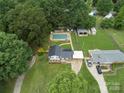 An aerial view captures the home, lush greenery, and a refreshing pool, all on a spacious lot at 1040 Spring Dr, Gastonia, NC 28052