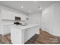 Stylish kitchen featuring a center island, sleek stainless steel appliances, and white cabinets at 1228 Hallman Branch Ln, Lincolnton, NC 28092