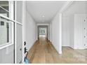 Bright foyer featuring hardwood floors and a view into the open-concept living spaces at 13618 Tranquil Day Dr, Matthews, NC 28105