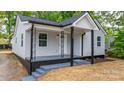 Inviting home with covered porch, decorative iron supports, and fresh exterior paint at 1440 10Th Sw Ave, Hickory, NC 28602