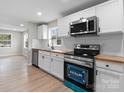 Well-lit kitchen boasts stainless steel appliances, wood countertops, and white subway tile at 1440 10Th Sw Ave, Hickory, NC 28602