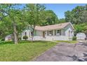 The home features a driveway and a well-kept lawn, adding to its welcoming charm at 1515 Edgewater Dr, Charlotte, NC 28210