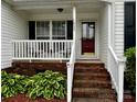Inviting front porch with brick steps, white railings and space for outdoor seating at 165 Kimball Rd, China Grove, NC 28023