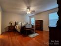 Comfortable main bedroom with hardwood floors, ceiling fan, and classic furnishings at 165 Kimball Rd, China Grove, NC 28023