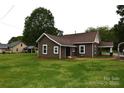 Rear view of a cozy home with a spacious yard, perfect for outdoor activities and relaxation at 175 Leonard Rd, Salisbury, NC 28146