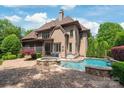 Beautiful backyard with a pool, spa, and patio, ideal for outdoor living and entertaining at 18843 Flat Shoals Dr, Cornelius, NC 28031