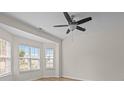 Bright bedroom with light-colored walls, wood floors, a ceiling fan, and large windows at 2018 Rockycreek Ln, Monroe, NC 28112