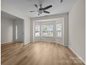 Inviting living room with wood floors, a ceiling fan, a bay window, and lots of natural light at 2018 Rockycreek Ln, Monroe, NC 28112