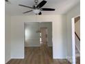Open-concept living room with views into the dining room and staircase; light flooring throughout at 2018 Rockycreek Ln, Monroe, NC 28112