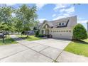 Charming single-Gathering home on a tree-lined street with a well-manicured lawn and two-car garage at 214 Blossom Ridge Dr, Mooresville, NC 28117