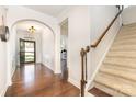Inviting foyer with hardwood floors, staircase, and arched entryway leading to other rooms at 214 Blossom Ridge Dr, Mooresville, NC 28117
