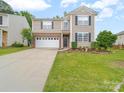 Lovely two-story home with a two car garage, well-kept lawn, and nicely landscaped flower beds at 2306 Nettleton Ct, Matthews, NC 28105